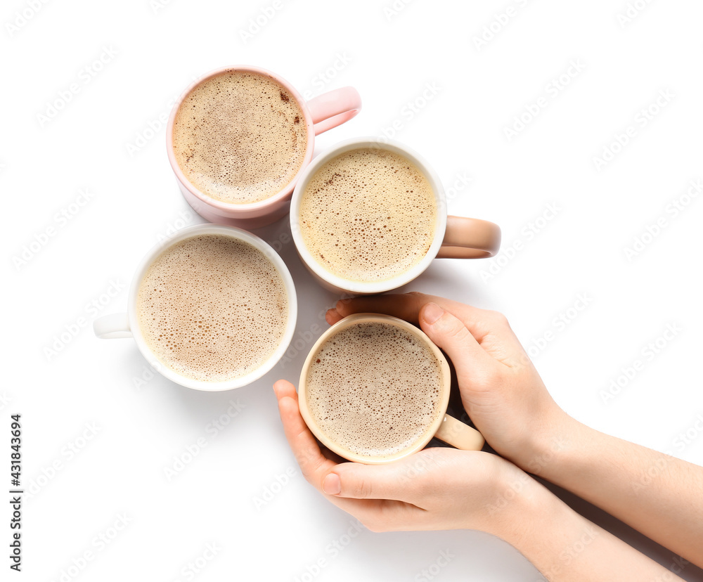 Female hands with cups of tasty coffee on white background