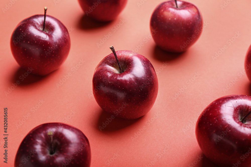 Fresh red apples on color background