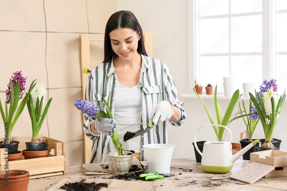 Female gardener taking care of plants at home