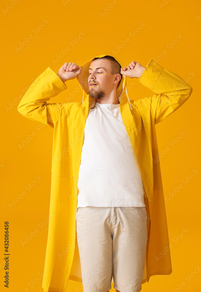 Stylish young man on yellow background