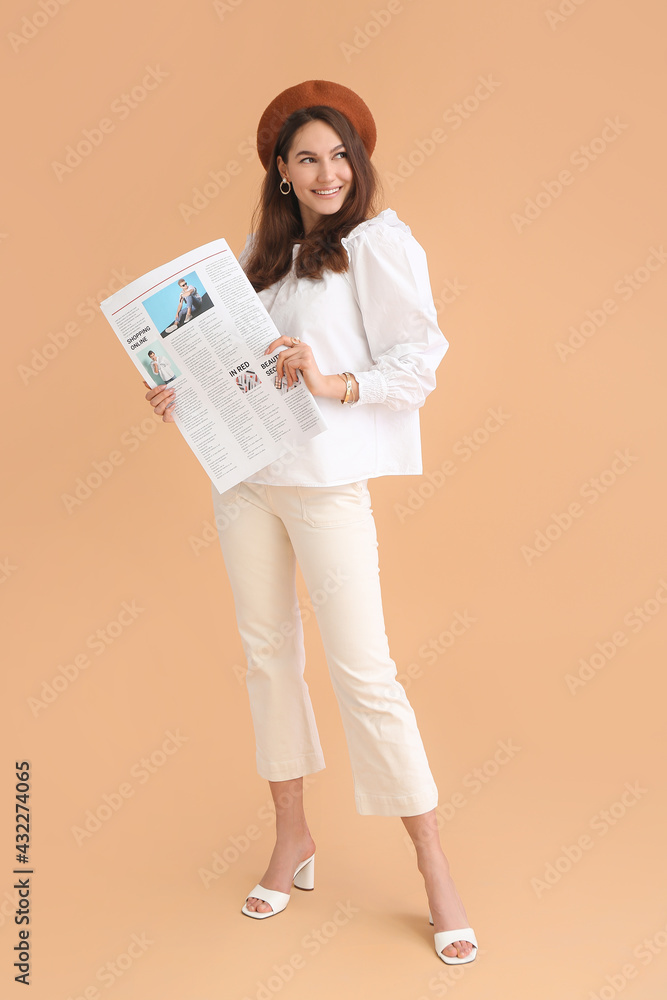 Young woman with newspaper on color background