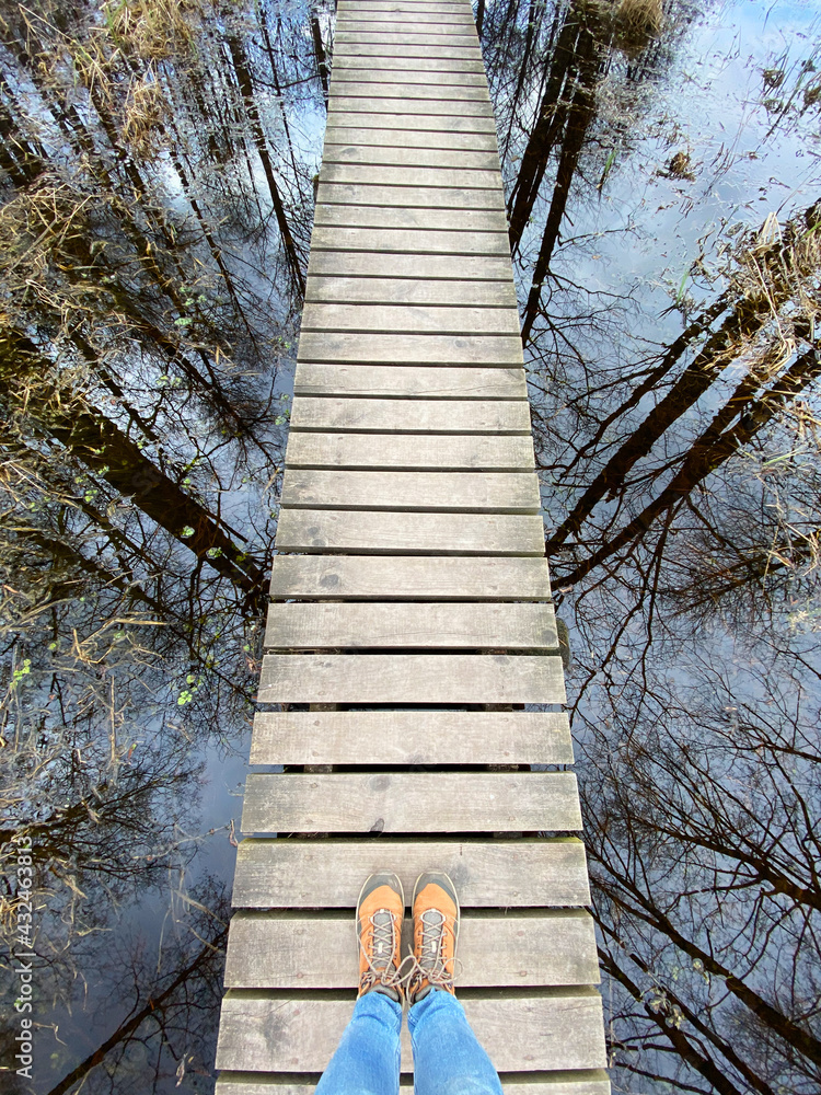 wooden footbridge through the lake nature trail