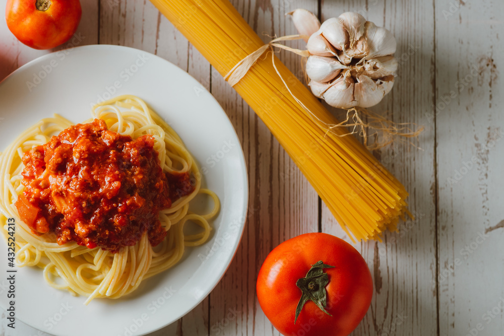 Delicious homemade Spaghetti pasta with tomato sauce and minced meat served on a white plate with in