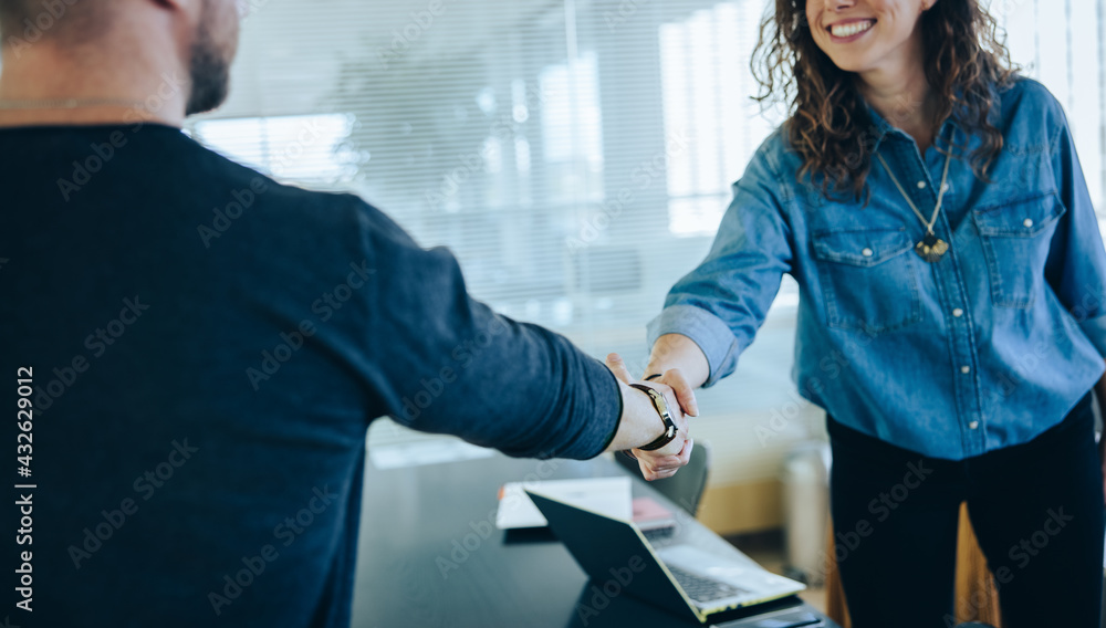 Two businesspeople handshake after meeting