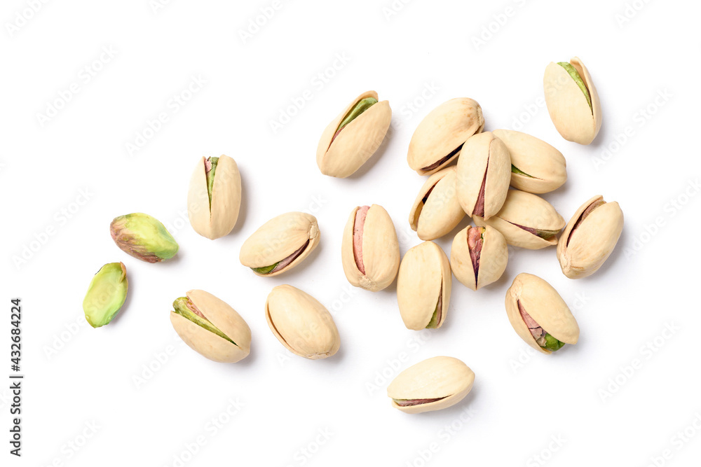 Flat lay of pistachio nuts on a white background.