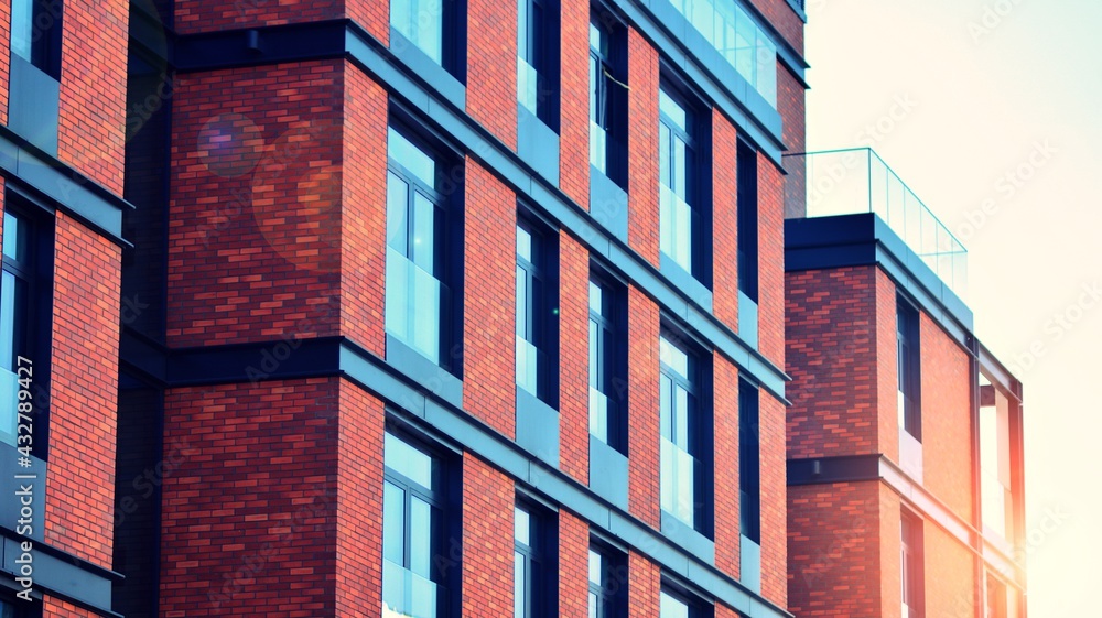 Architectural exterior detail of residential apartment building with brick facade. Modern brick and 