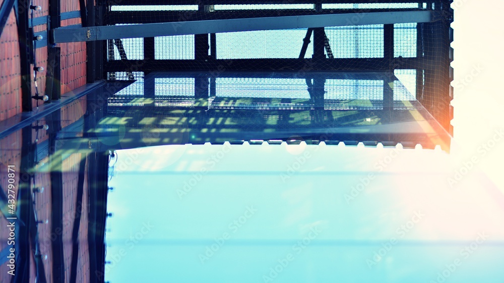 Modern building in the city with sunlight. Abstract texture and blue glass facade in modern office b