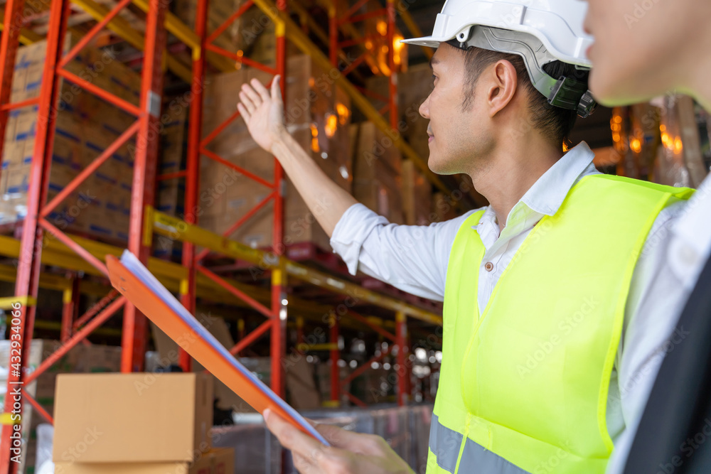 Warehouse worker talking with customer about storage department controlling distribution to the mark