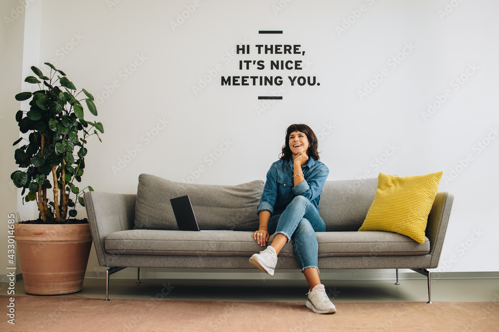 Cheerful entrepreneur sitting at lobby