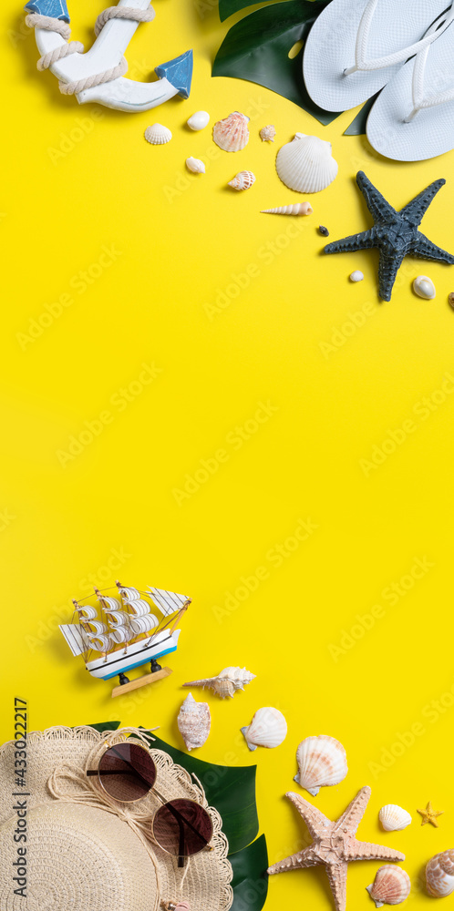 Summer beach design concept with shells, hat, slipper on yellow background.