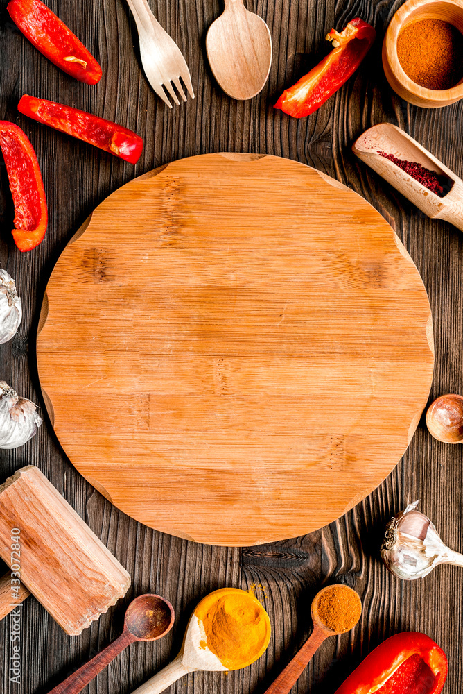 Professional kitchen with spices for cook on wooden background top view