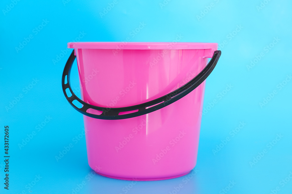 Plastic bucket on color background