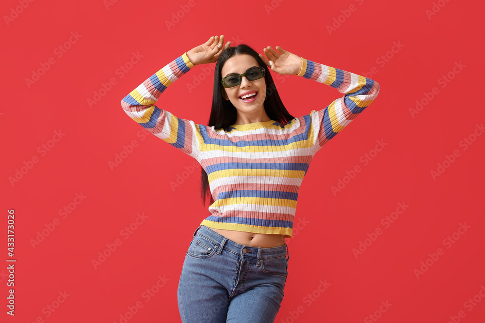 Beautiful young woman wearing stylish sunglasses on color background