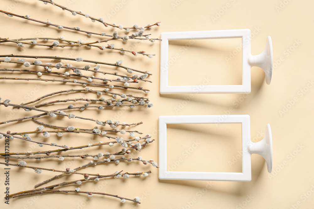 Willow branches and frames on color background