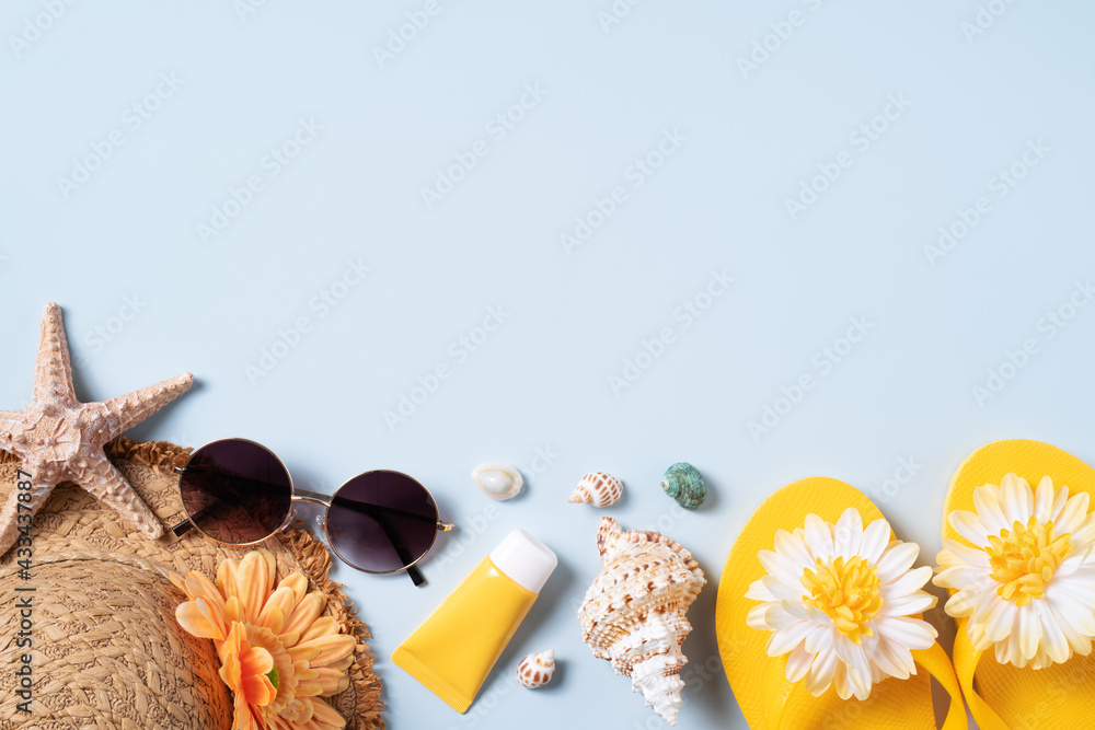 Summer beach background design concept with shells, hat, slipper on yellow background.