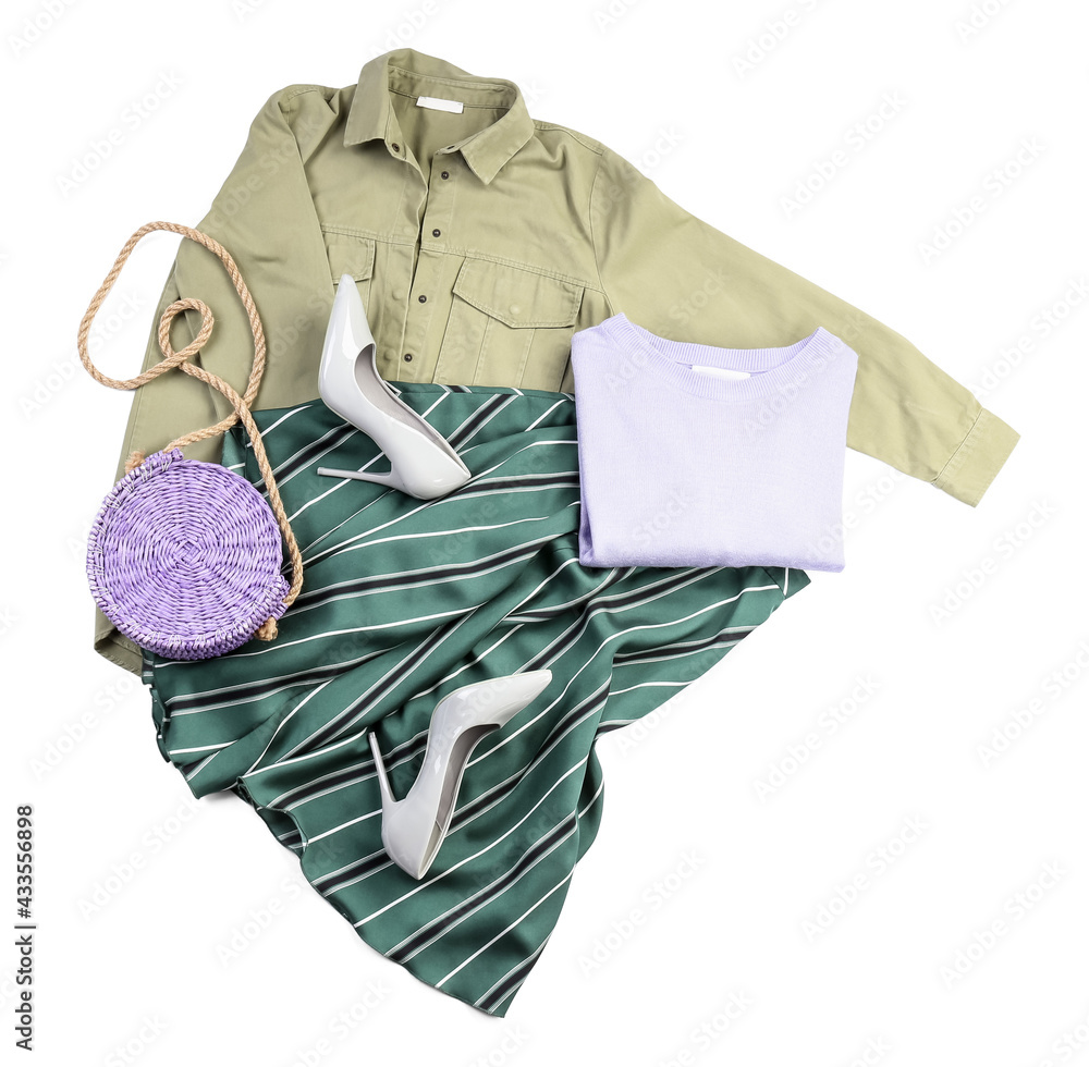 Stylish female clothes with accessories on white background