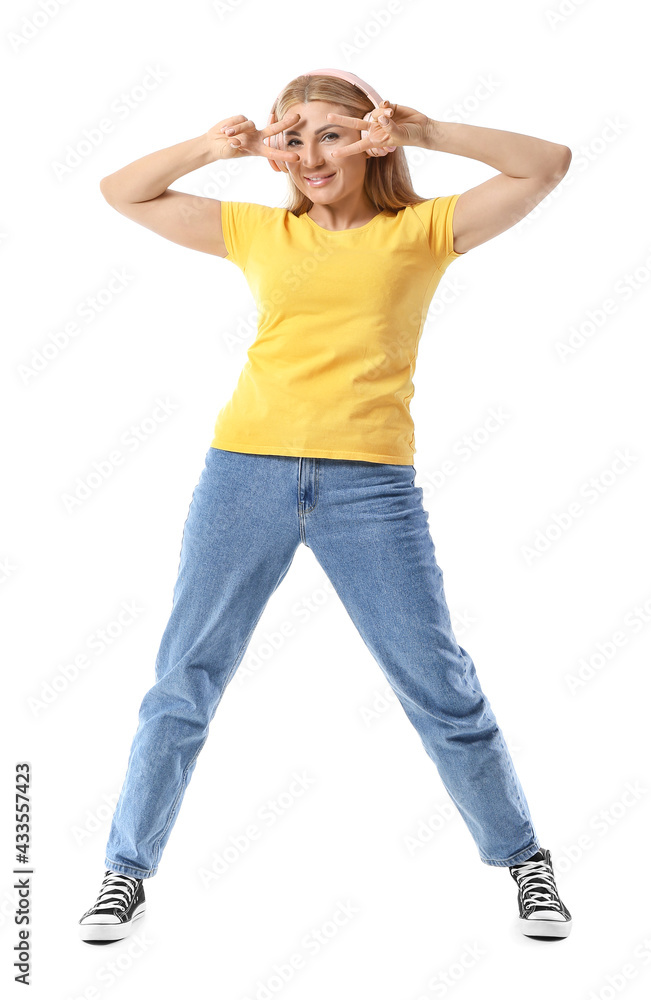 Beautiful woman listening to music on white background