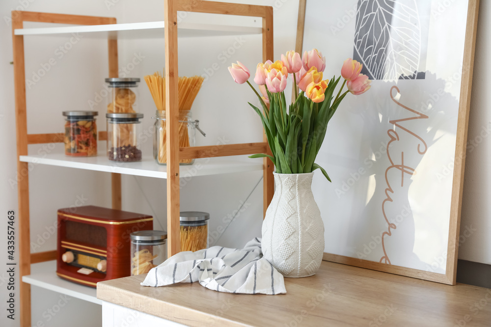 Bouquet of beautiful tulip flowers on counter in kitchen