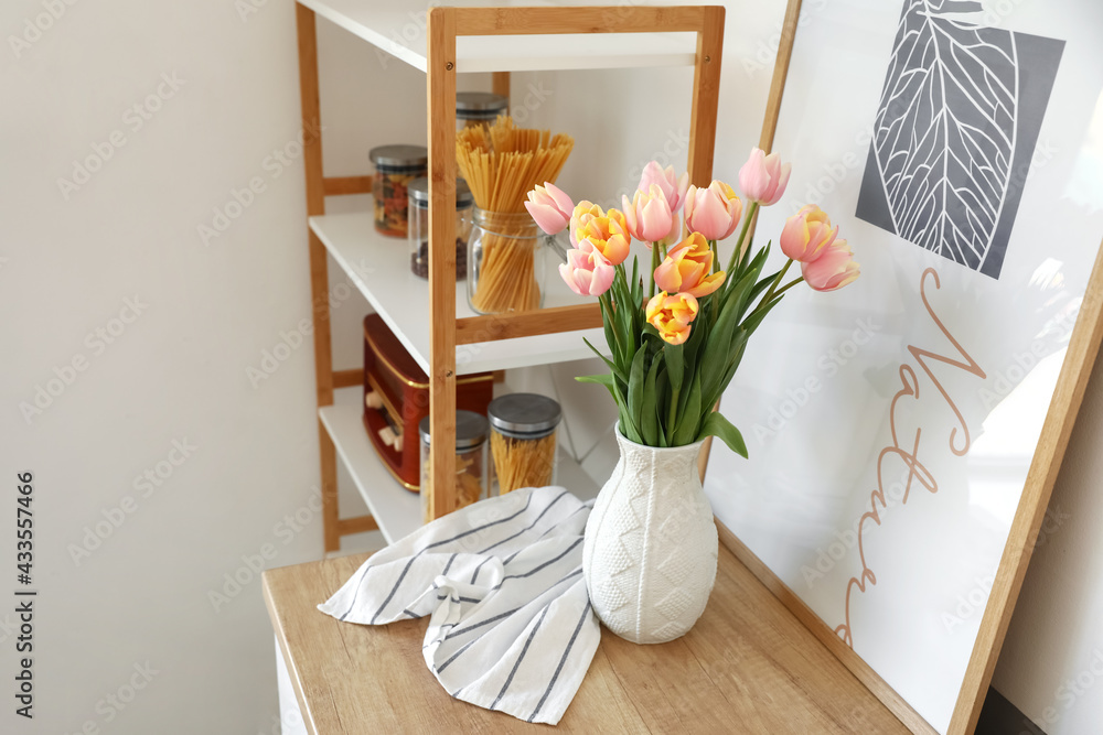 Bouquet of beautiful tulip flowers on counter in kitchen