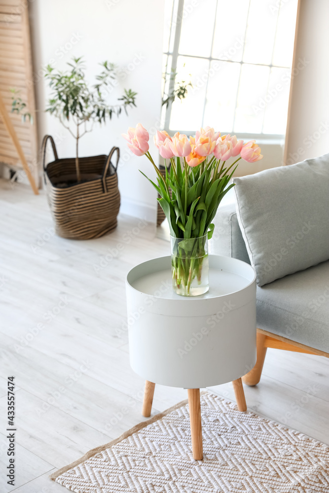 Bouquet of beautiful tulip flowers on table in modern room