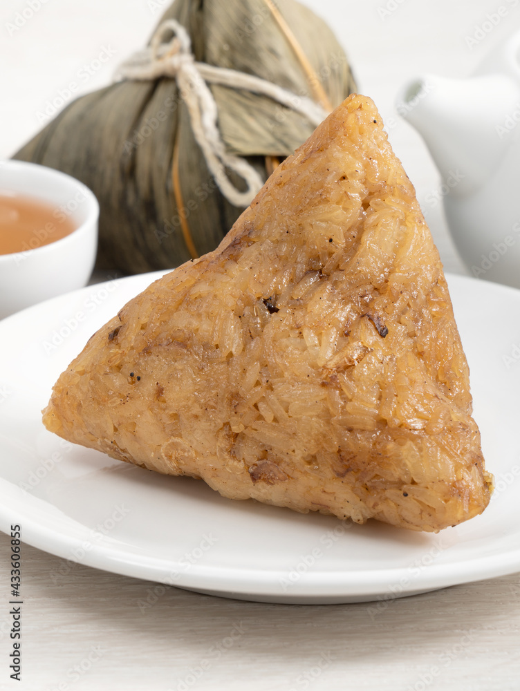 Zongzi. Rice dumpling for Dragon Boat Festival on bright wooden table background.