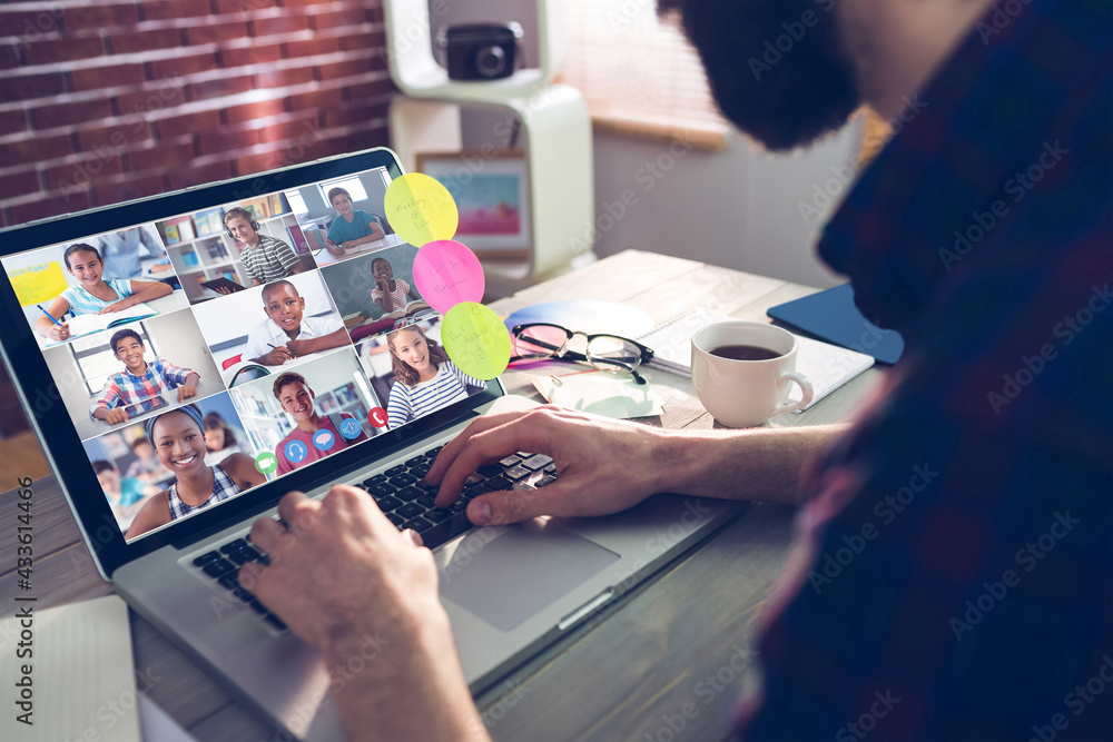 Caucasian businessman sitting at desk using laptop having video call