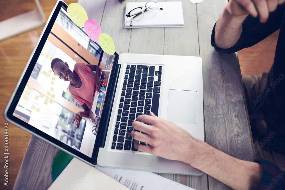 Caucasian businessman sitting at desk using laptop having video call with female colleague