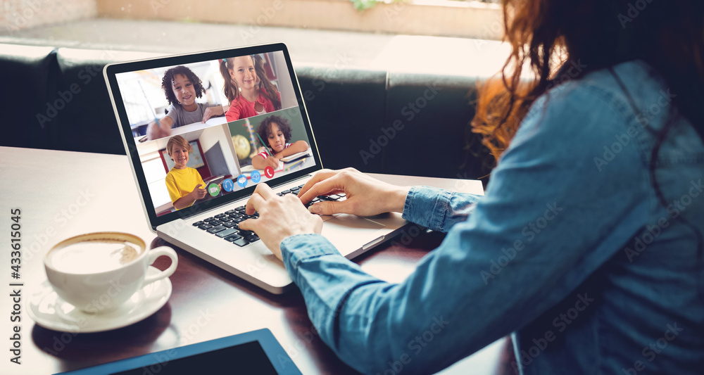 Caucasian businesswoman sitting at desk using laptop having video call