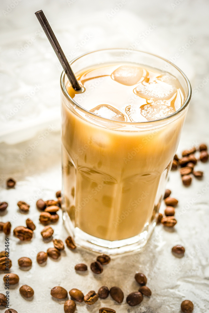 coffee ice cubes and beans with latte on stone desk background