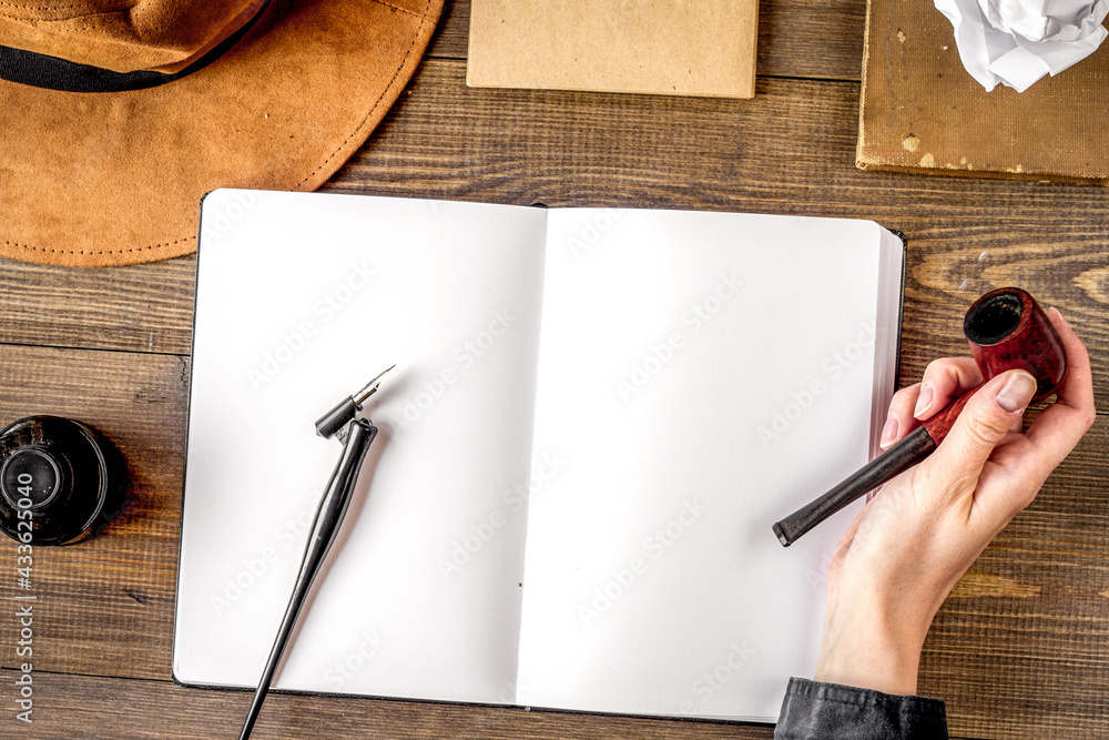 writer workplace with tools on wooden background top view