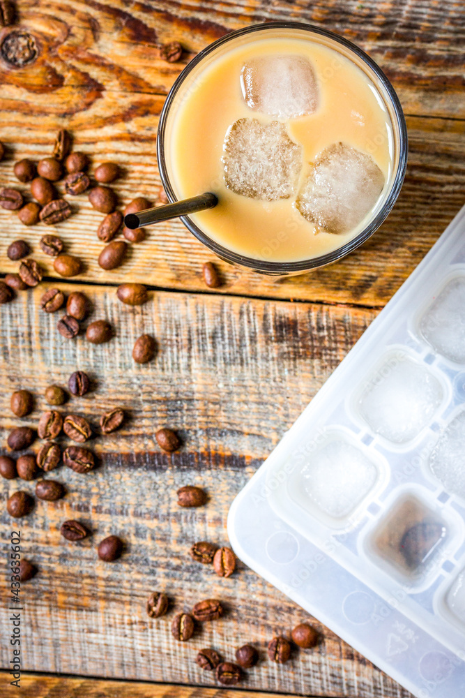 coffee ice cubes and beans with latte on wooden desk background top view