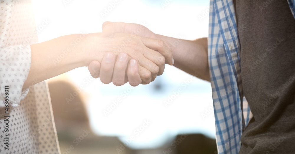 Composition of man and woman shaking hands