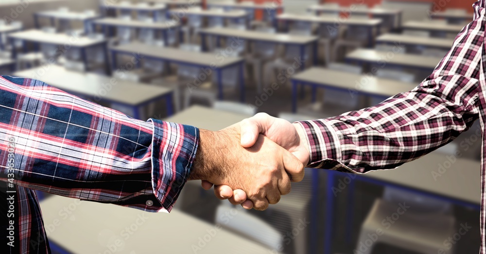 Composition of men shaking hands in classroom