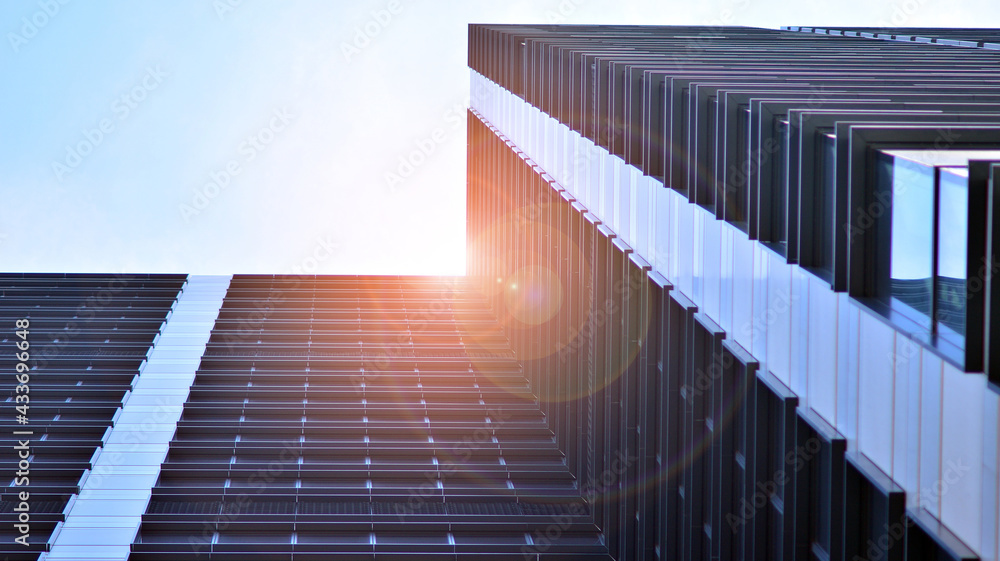 Modern architecture with sun ray. Glass and steel facade on a bright sunny day with sunbeams on the 