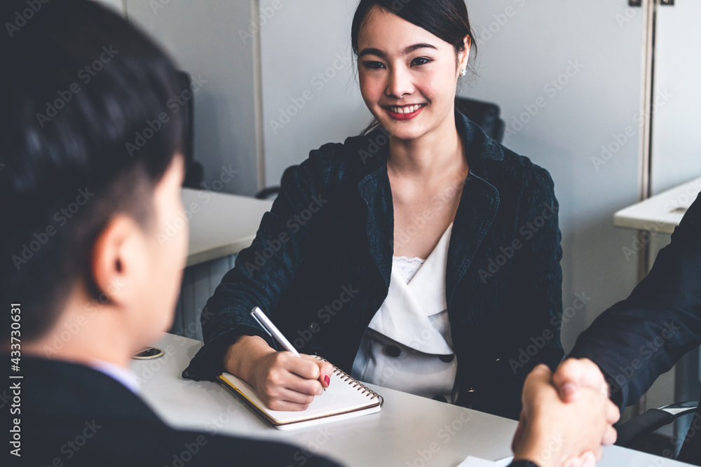 Business people agreement concept. Asian Businessman do handshake with another businessman in the of