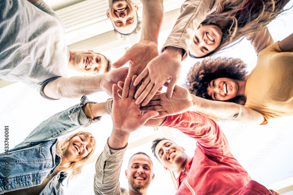 Young happy people stacking hands together outcoor - Community of multiracial international people s