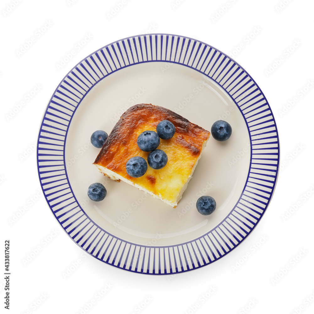 Plate with piece of cottage cheese casserole on white background