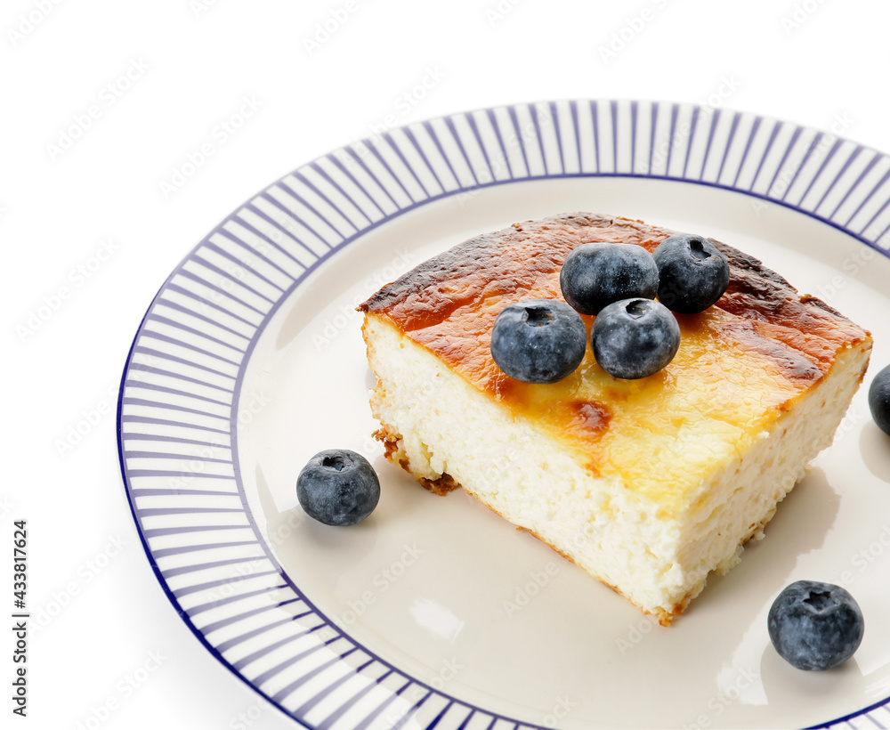 Plate with piece of cottage cheese casserole on white background