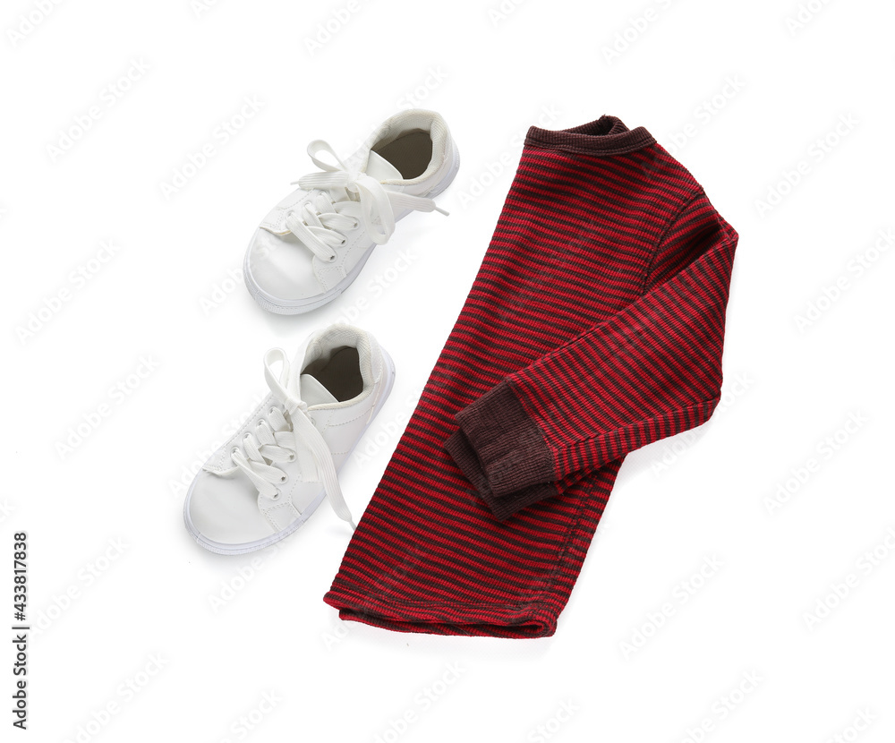 Childs shirt and shoes on white background