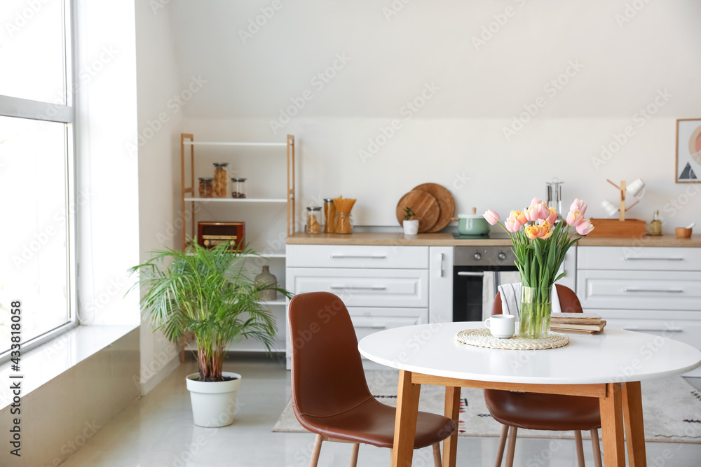 Bouquet of beautiful tulip flowers on table in kitchen