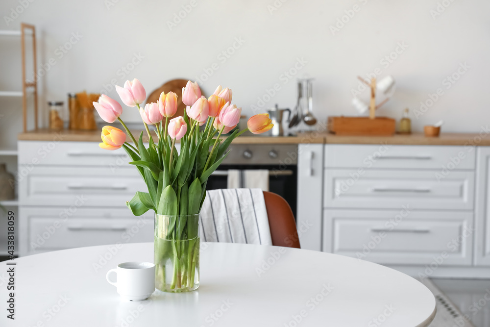 Bouquet of beautiful tulip flowers on table in kitchen