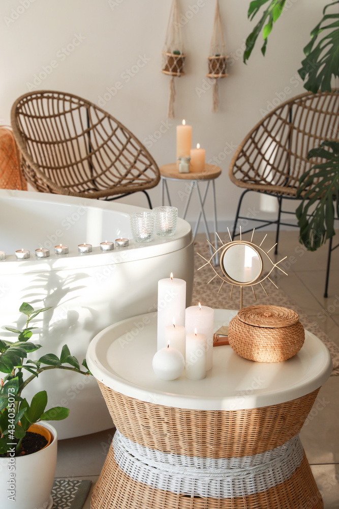 Stylish interior of modern bathroom with burning candles