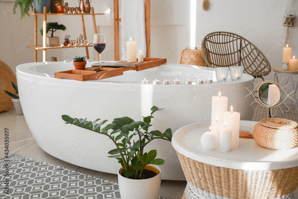 Stylish interior of modern bathroom with burning candles