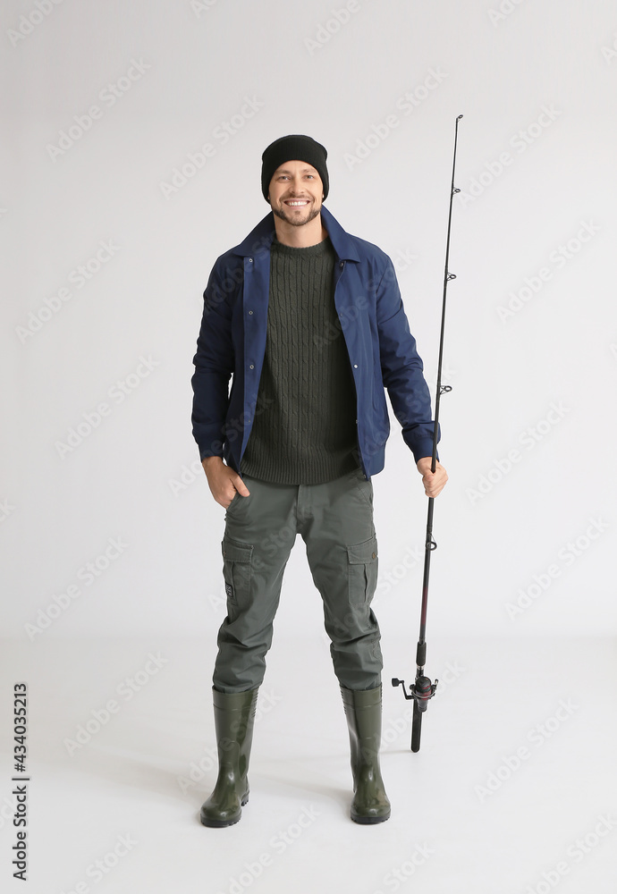 Man with fishing rod on white background