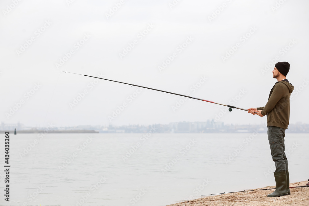 Man fishing on river bank