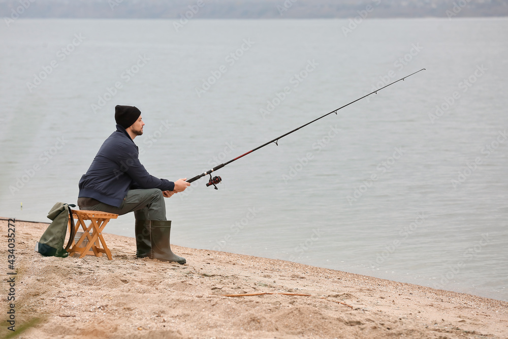 Man fishing on river bank