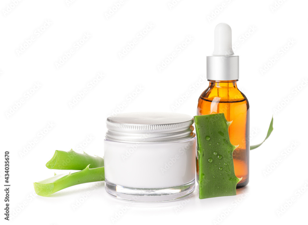 Jar with cream, bottle of essential oil and aloe pieces on white background