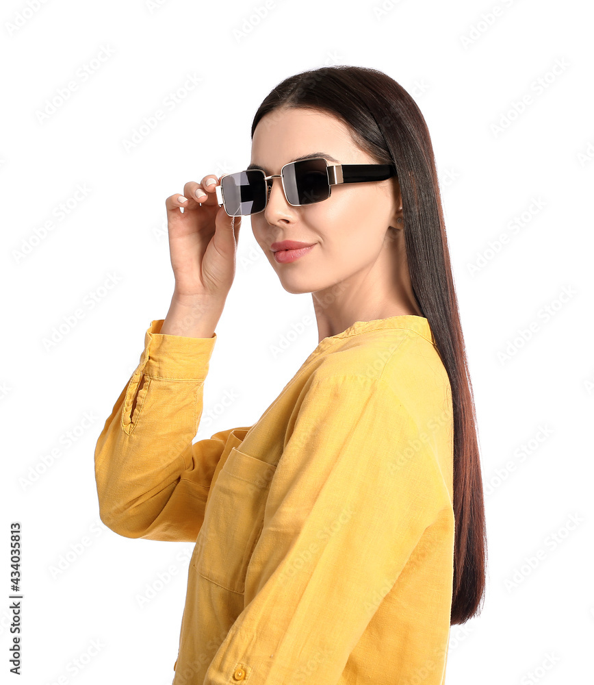 Beautiful young woman wearing stylish sunglasses on white background