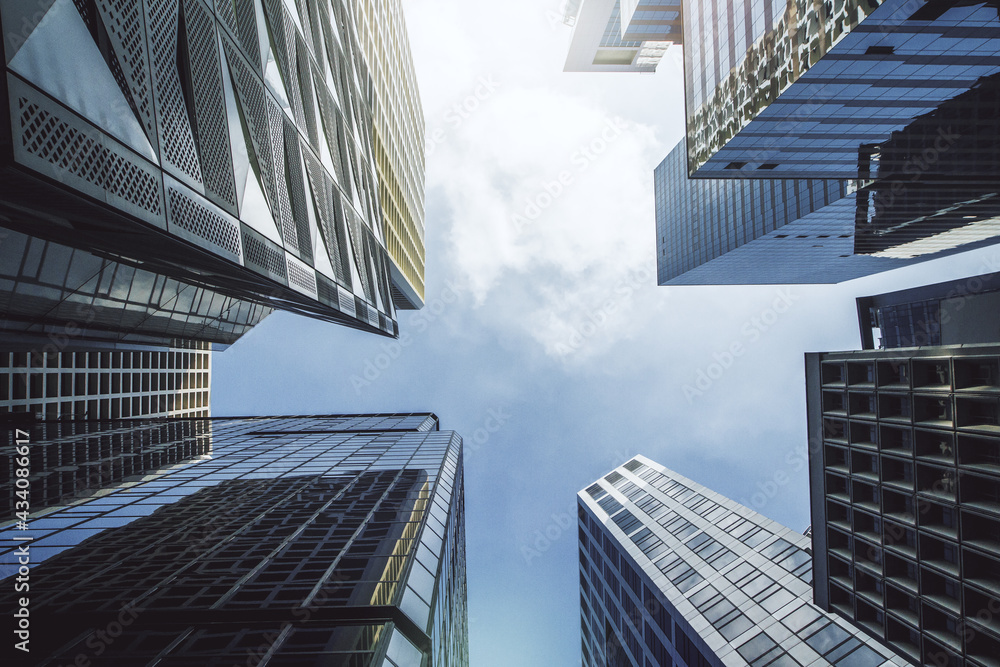 Modern wallpaper with business center buildings on blue sky backdrop.