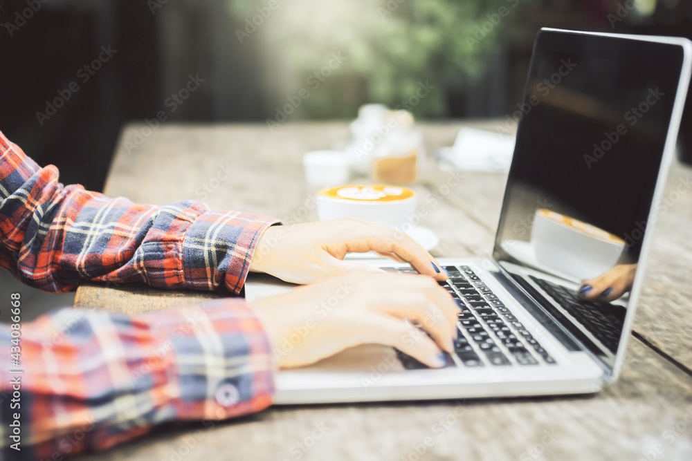 Online studying and education concept with hipster hands typing on laptop keyboard at outdoor coffee